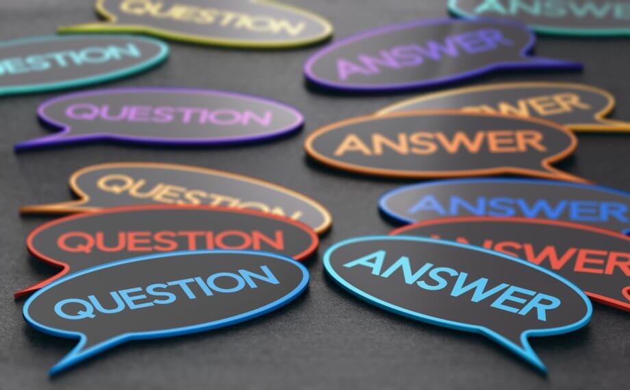 Photograph of speech bubbles with the words "Question" in some of them and "Answer" in others on a dark surface.